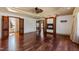 A spacious living room with hardwood floors, a ceiling fan, and an ornate fireplace at 2421 Acanthus Dr, Wake Forest, NC 27587