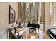 Elegant music room filled with natural light, a grand piano, and marble floors at 2421 Acanthus Dr, Wake Forest, NC 27587
