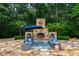 Charming backyard with a stone fireplace, comfortable seating, and vibrant greenery at 2421 Acanthus Dr, Wake Forest, NC 27587