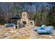 Stone outdoor fireplace with seating area and lounge chairs on a flagstone patio at 2421 Acanthus Dr, Wake Forest, NC 27587