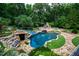 Aerial view of the backyard pool with a waterslide feature and fireplace at 2421 Acanthus Dr, Wake Forest, NC 27587