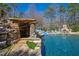 Unique pool grotto with natural stone, slide, and waterfall features, creating a relaxing and fun backyard oasis at 2421 Acanthus Dr, Wake Forest, NC 27587