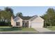 Charming single-Gathering home featuring stone accents, a two-car garage, and a well-manicured lawn at 244 St Andrews Dr, Zebulon, NC 27597