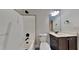 Modern bathroom featuring a dark wood vanity, toilet, and tiled shower-tub combination at 257 Swann Trl, Clayton, NC 27527