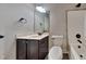 Well-lit bathroom with a wood vanity, white marble countertop, and a shower and tub combo at 257 Swann Trl, Clayton, NC 27527