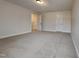 Bedroom showing open closet and neutral carpeting at 257 Swann Trl, Clayton, NC 27527
