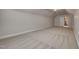 Spacious bonus room in neutral tones with plush carpet and a doorway to a hallway at 257 Swann Trl, Clayton, NC 27527