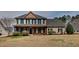 Charming two-story home featuring a welcoming front porch and well-maintained landscaping at 257 Swann Trl, Clayton, NC 27527