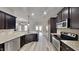 Modern kitchen features granite counters, stainless appliances, and wood cabinetry at 257 Swann Trl, Clayton, NC 27527