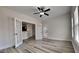 Bright living room showing elegant floors and adjacent kitchen area through white french doors at 257 Swann Trl, Clayton, NC 27527