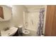 Conventional bathroom with a shower-tub combo, vanity sink, round mirror, and a toilet at 2726 Thelma St, Durham, NC 27704