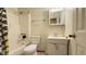 Traditional bathroom with a shower-tub combo, vanity sink, medicine cabinet, and a toilet at 2726 Thelma St, Durham, NC 27704