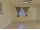 Bright living room featuring a large window with curtains and hardwood flooring at 2726 Thelma St, Durham, NC 27704