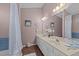 Charming bathroom with double sink vanity, decorative mirrors, and vintage accents at 300 Pate St, Apex, NC 27502