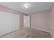 Bedroom with pink walls and neutral carpet features closet and a view into the next room at 300 Pate St, Apex, NC 27502