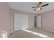 Bedroom with pink walls and neutral carpet features closet and a view into the next room at 300 Pate St, Apex, NC 27502