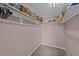 Walk-in closet with ample storage space featuring shelving and carpet flooring at 300 Pate St, Apex, NC 27502