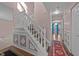 Hallway with decorative wainscoting, staircase, and views into other living spaces at 300 Pate St, Apex, NC 27502