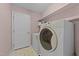 Bright laundry room with washer, dryer, and storage shelves at 300 Pate St, Apex, NC 27502