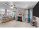 A comfortable living room offers a fireplace, big windows, and access to the kitchen at 300 Pate St, Apex, NC 27502