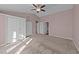 Expansive main bedroom with vaulted ceiling, fan, closet space, and multiple doorways at 300 Pate St, Apex, NC 27502