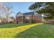 Brick home featuring a spacious backyard, screened porch and wooden fence at 3109 Doe Hill Ct, Raleigh, NC 27612