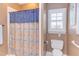 This bathroom features a shower, toilet and window at 3109 Doe Hill Ct, Raleigh, NC 27612