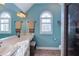 Bright bathroom featuring a large vanity, an arched window, and a glass enclosed shower at 3109 Doe Hill Ct, Raleigh, NC 27612