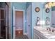 Bright bathroom featuring a large vanity, an arched window, and a glass enclosed shower at 3109 Doe Hill Ct, Raleigh, NC 27612