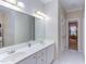 This bathroom features a double sink vanity with a large mirror at 3109 Doe Hill Ct, Raleigh, NC 27612