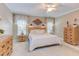 This bedroom features neutral walls, white curtains, and furnishings at 3109 Doe Hill Ct, Raleigh, NC 27612