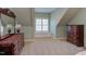 Neutral bedroom featuring a built in window seat, two dressers, and neutral carpeting at 3109 Doe Hill Ct, Raleigh, NC 27612