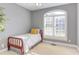 This bedroom features a single bed, large window and gray walls at 3109 Doe Hill Ct, Raleigh, NC 27612