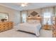 Bright bedroom featuring natural wood furniture, a queen-size bed, and neutral paint at 3109 Doe Hill Ct, Raleigh, NC 27612