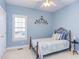 This bedroom features blue walls and iron bed frame at 3109 Doe Hill Ct, Raleigh, NC 27612
