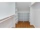 Walk-in closet with built-in shelving and hardwood floors at 3109 Doe Hill Ct, Raleigh, NC 27612