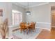 Dining room featuring a wooden table, rug, hardwood floors, and natural light at 3109 Doe Hill Ct, Raleigh, NC 27612