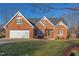 Charming brick home with manicured lawn, attached garage and detailed architectural trim at 3109 Doe Hill Ct, Raleigh, NC 27612