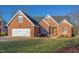 Charming brick home with manicured lawn, attached garage and detailed architectural trim at 3109 Doe Hill Ct, Raleigh, NC 27612