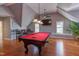Game room with a red felt billiards table, wood floors, and seating area at 3109 Doe Hill Ct, Raleigh, NC 27612