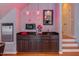 Game room with a wet bar that includes a mini fridge and microwave at 3109 Doe Hill Ct, Raleigh, NC 27612