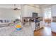 Open concept kitchen with granite countertop island, stainless steel appliances, and white cabinets at 3109 Doe Hill Ct, Raleigh, NC 27612