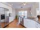 Bright eat-in kitchen with stainless steel appliances, granite countertops, and hardwood floors at 3109 Doe Hill Ct, Raleigh, NC 27612
