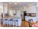 Bright kitchen with granite countertops, stainless steel appliances, white cabinets, and hardwood floors at 3109 Doe Hill Ct, Raleigh, NC 27612