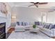 Open-concept living room with hardwood floors, leading into dining and kitchen areas at 3109 Doe Hill Ct, Raleigh, NC 27612
