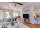 Open-concept living room with hardwood floors, leading into dining and kitchen areas at 3109 Doe Hill Ct, Raleigh, NC 27612