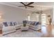 Bright living room with fireplace, hardwood floors, ceiling fan, and a comfortable sectional sofa at 3109 Doe Hill Ct, Raleigh, NC 27612