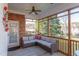 Screened-in porch with brick accents, fan, and outdoor furniture at 3109 Doe Hill Ct, Raleigh, NC 27612