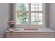 Window seat offers a cozy spot with Wolfpack decor, perfect for relaxation and enjoying natural light at 3109 Doe Hill Ct, Raleigh, NC 27612