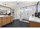 Modern bathroom with double vanities, a glass-enclosed shower, and elegant fixtures at 353 Belmont Stakes Ln, Wendell, NC 27591